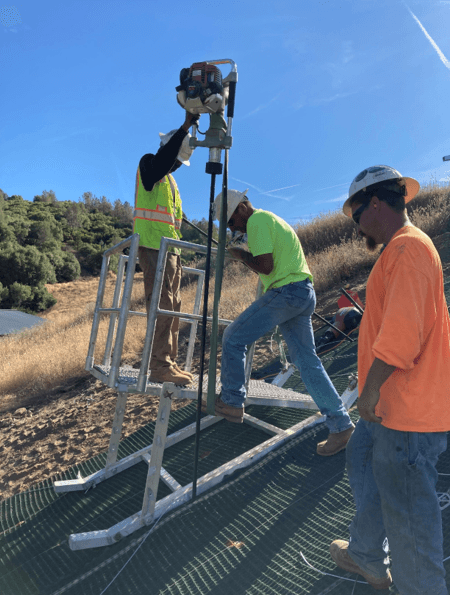 Workers secured the PROPEX Pyramat 75 HPTRM with engineered anchors, ensuring permanent slope stability and effective load distribution