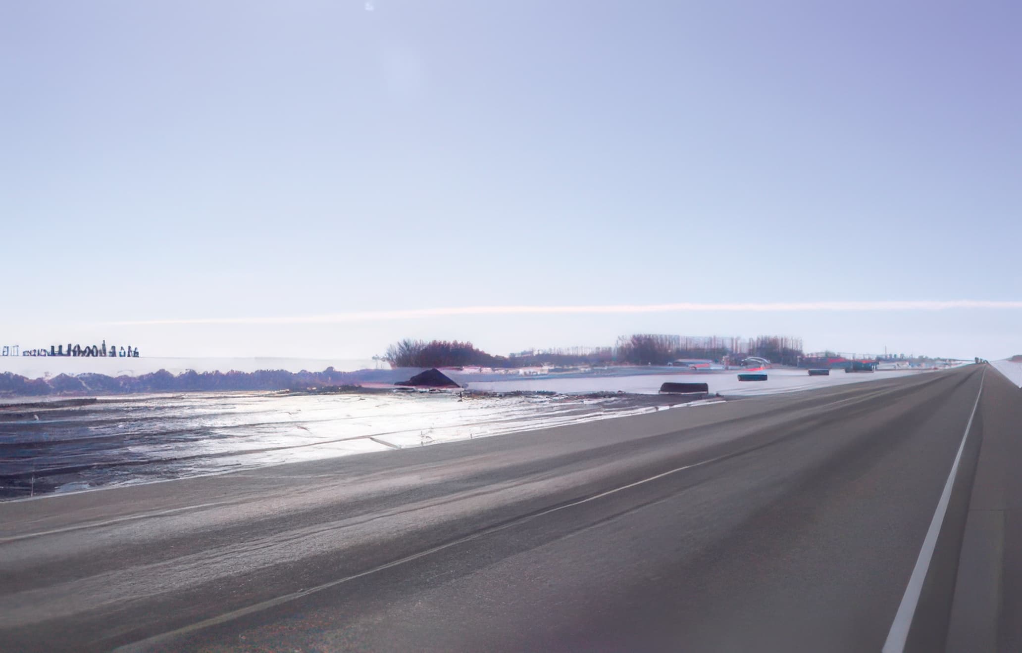 Embankment construction underway on frozen ground, reducing environmental impact and improving foundation stability