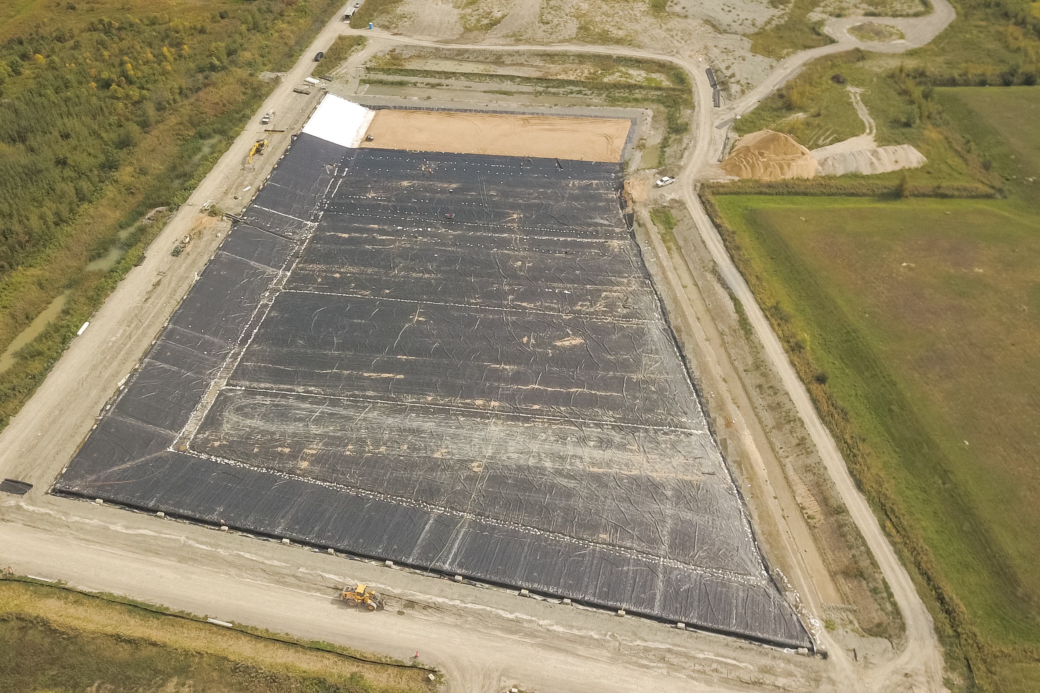 Installation of the GSE HD geomembrane and MIRAFI nonwoven geotextile forming the primary barrier system for Cell A1’s contaminated-soil containment upgrade.
